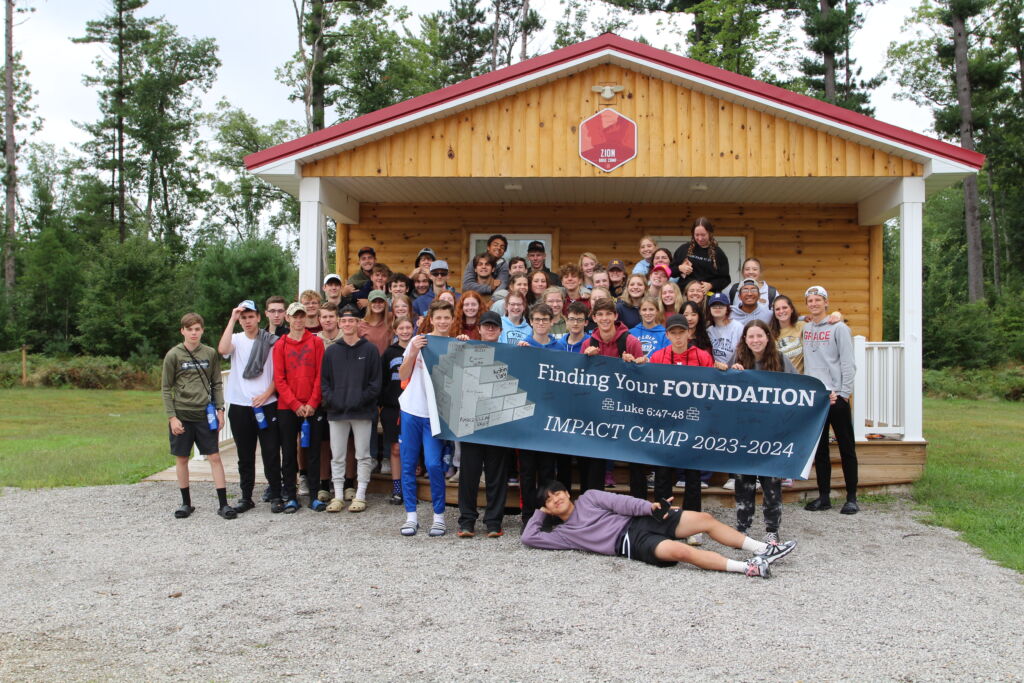 Impact camp with banner (1)